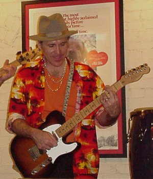 Matt playing guitar in a power trio.